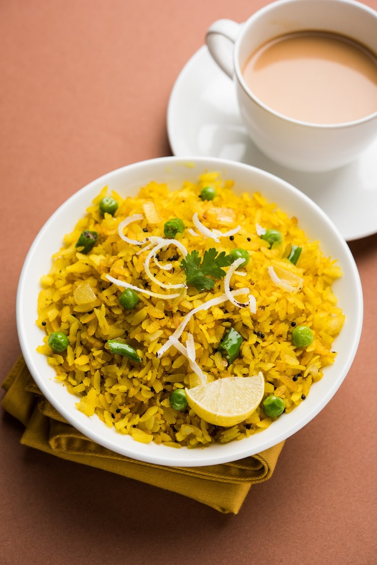 indian-breakfast-dish-poha-also-know-as-pohe-aalu-poha-made-up-beaten-rice-flattened-rice-rice-flakes-are-lightly-fried-oil-with-spices-served-with-hot-tea_466689-59065